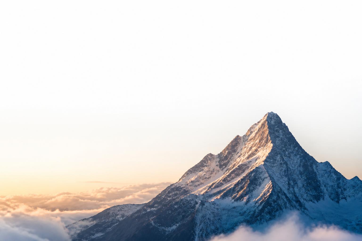 Mountain peak rising above the clouds
